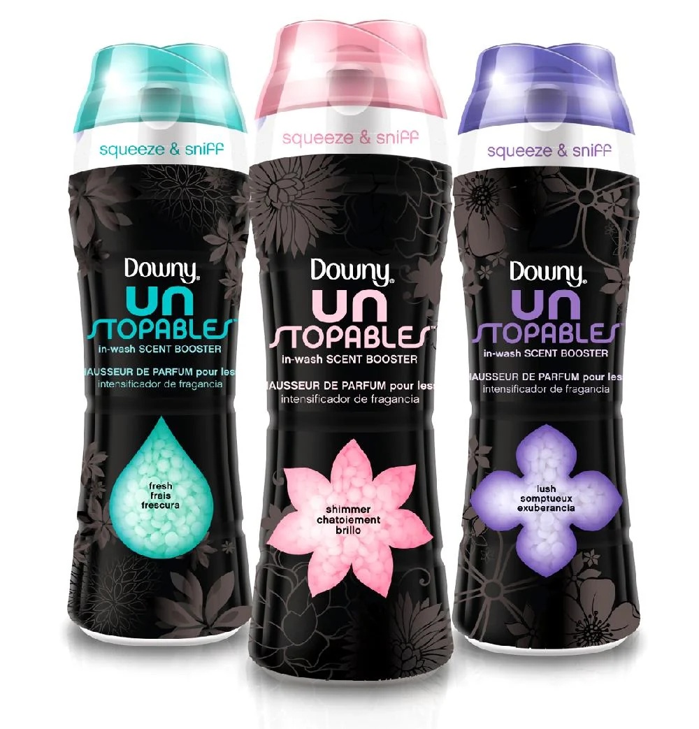 Three Downy Unstopables bottles with turquoise, pink and purple caps